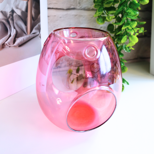 Add a touch of Sophistication and Style to your home with our stunning Pink Glass Wax Melt Burner. With its high-gloss finish and soft pink hue, this burner is the perfect blend of sophistication and modern elegance. Whether you’re looking to enhance your space with a decorative accent or indulge in your favourite home fragrances, this piece is a must-have.

Designed for both beauty and function, its open-cut design ensures optimal fragrance release, allowing your home to be filled with long-lasting.